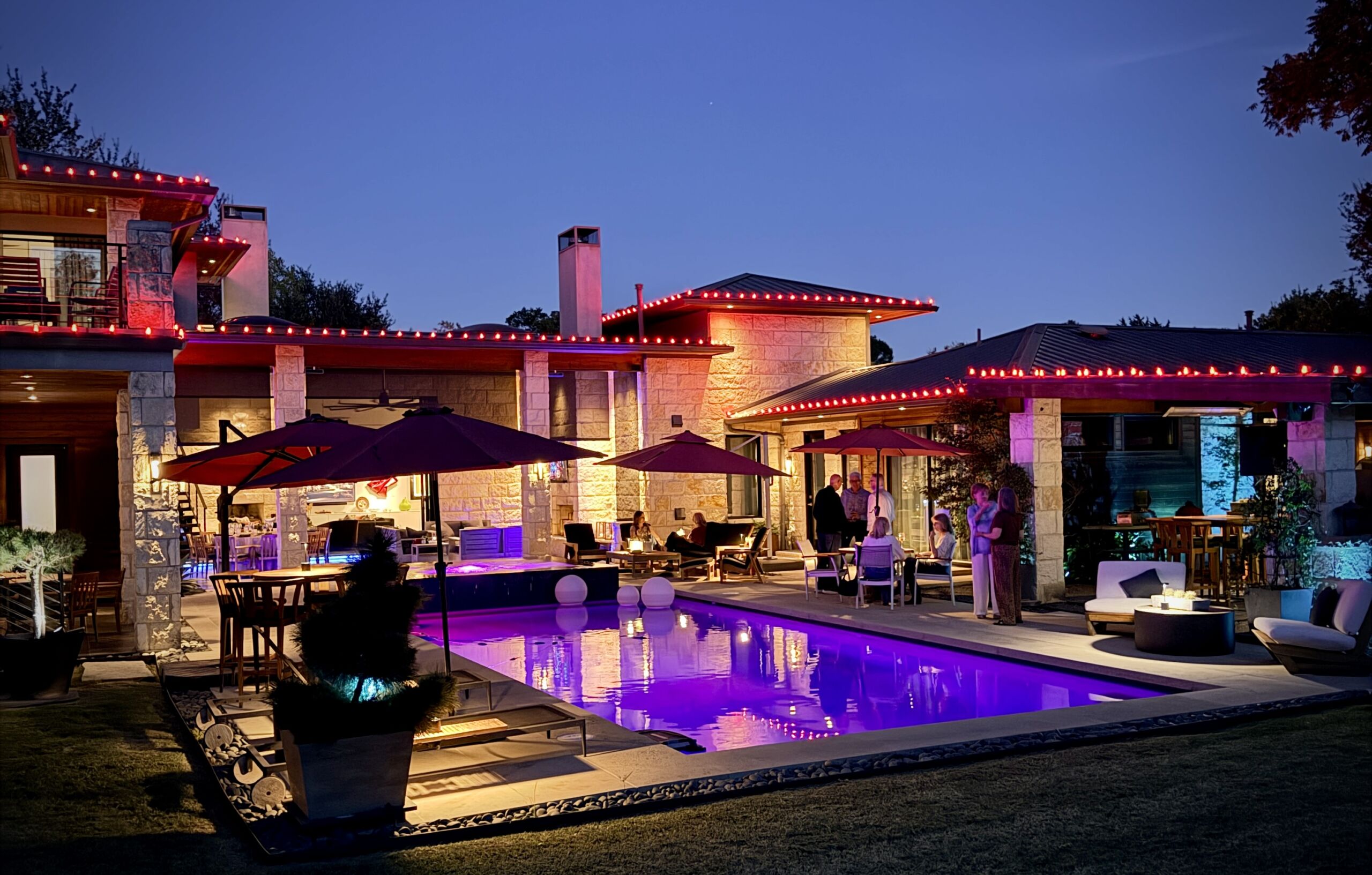 A catered backyard party at dusk in Dallas by Chef Kent Rathbun